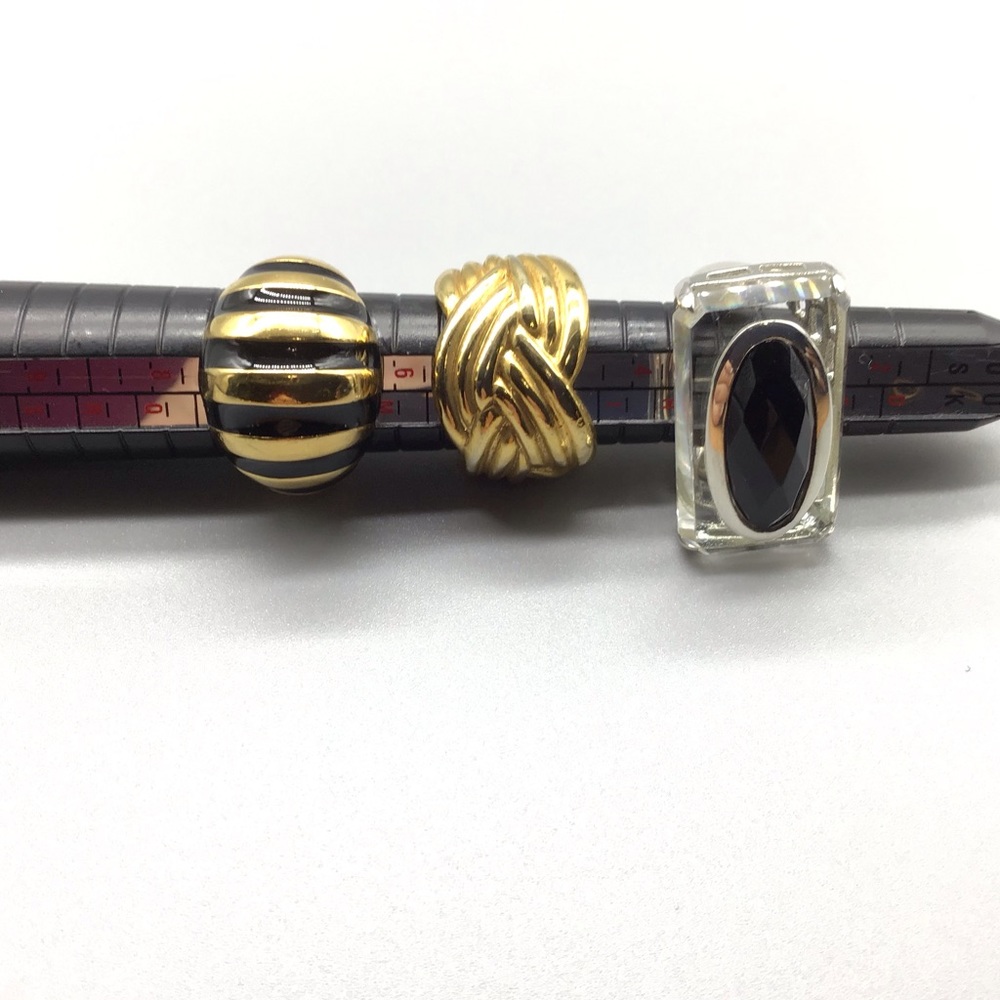 Lot of three gold tone and silver tone rings.